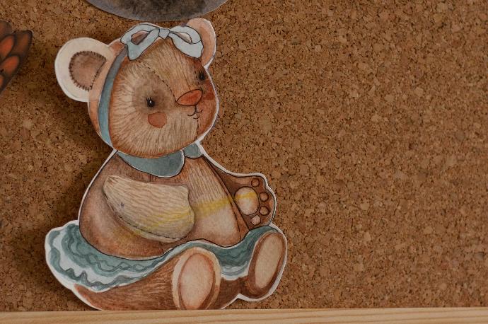 a picture of a teddy bear on a cork board